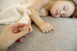 Child laying on carpet